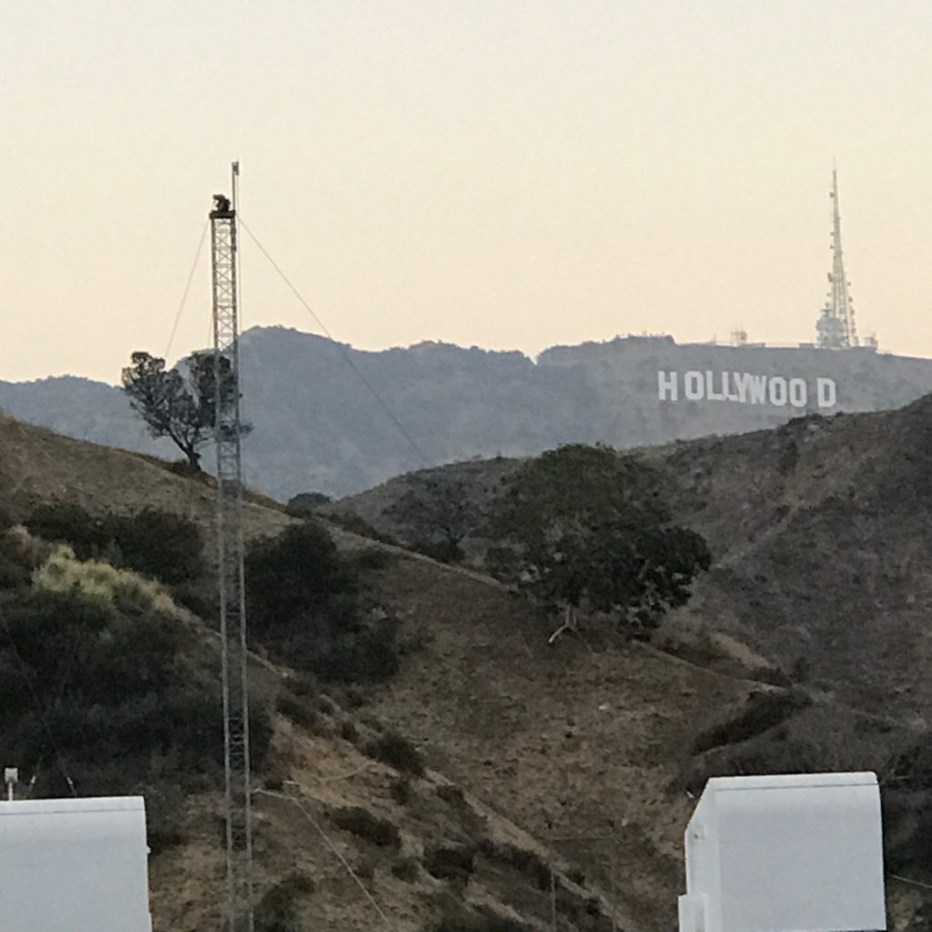 Image is a zoom of the famous Hollywood sign in the dusky light of the hills behind the Hollywood Bowl.